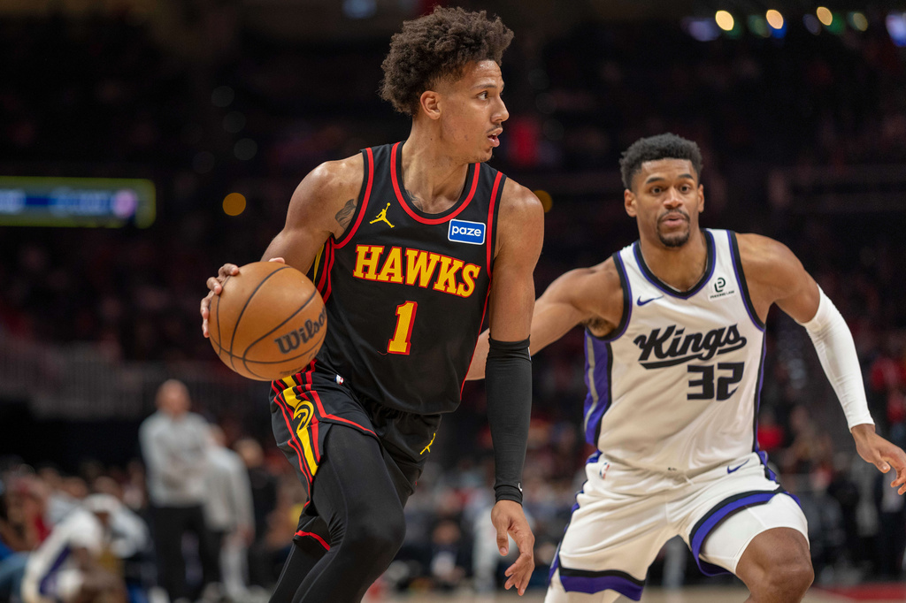 Atlanta Hawks forward Jalen Johnson (1) drives the ball against Sacramento Kings center Dylan Cardwell (32) during the first half of an NBA basketball game, Saturday, March 28, 2026, in Atlanta. (AP Photo/Erik Rank)