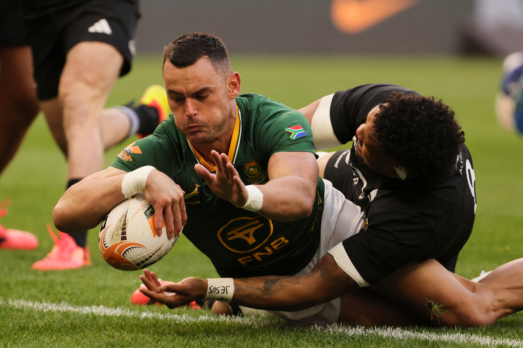 South Africa's Jesse Kriel, left, scores a try as New Zealand's captain Ardie Savea tries to defend during a second Test rugby match between South Africa and New Zealand, in Cape Town, South Africa, Saturday, Aug. 29, 2026. (AP Photo/Halden Krog)