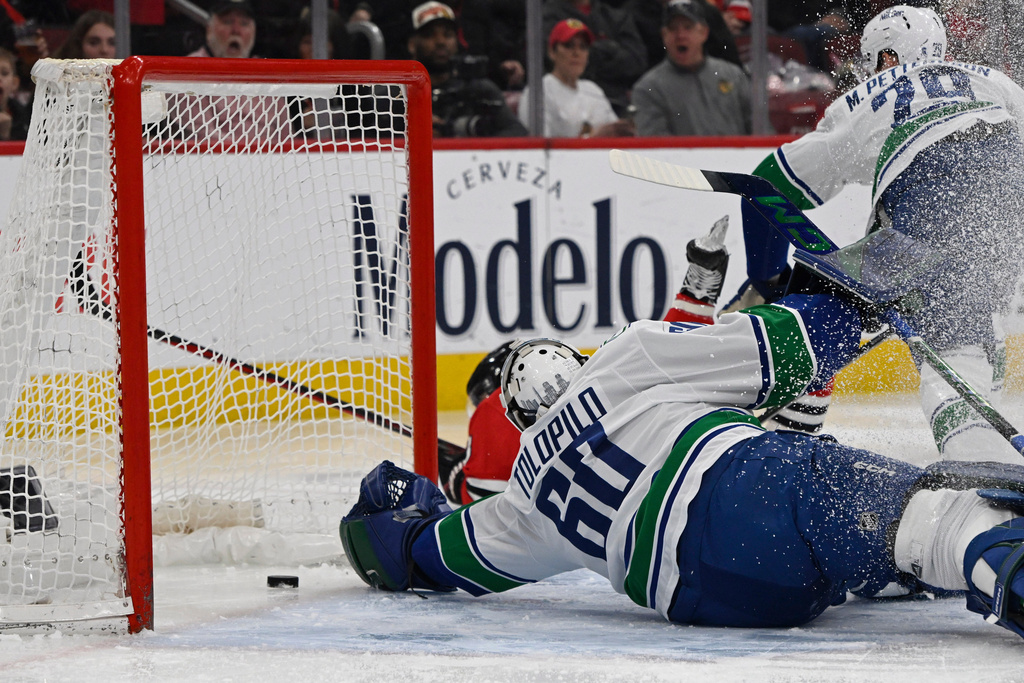 Vancouver Canucks goalie Nikita Tolopilo (60) misses a goal by Chicago Blackhawks' Ryan Donato during the first period of an NHL hockey game in Chicago, Friday, March 6, 2026. (AP Photo/Paul Beaty)