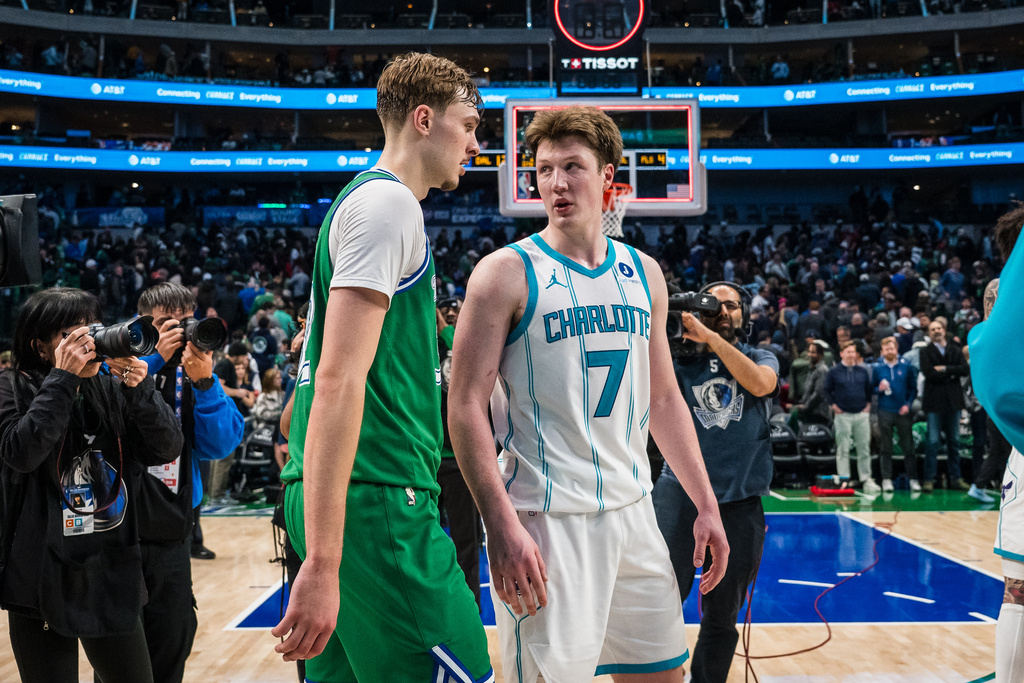 Dallas Mavericks forward Cooper Flagg, center left, and Charlotte Hornets guard Kon Knueppel (7) talk after an NBA basketball game, Thursday, Jan. 29, 2026, in Dallas. (AP Photo/Jessica Tobias)