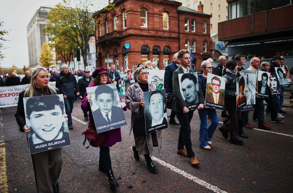 Relatives and supporters of the victims of the 1972 Bloody Sunday massacre march to Belfast Crown Court ahead of the verdict on the trial of a British soldier identified only as Soldier F, Belfast, in Northern Ireland, Thursday, Oct. 23, 2025. (AP Photo/Peter Morrison)