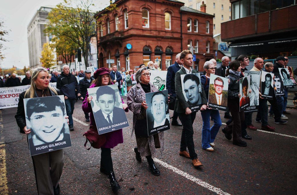 Relatives and supporters of the victims of the 1972 Bloody Sunday massacre march to Belfast Crown Court ahead of the verdict on the trial of a British soldier identified only as Soldier F, Belfast, in Northern Ireland, Thursday, Oct. 23, 2025. (AP Photo/Peter Morrison)