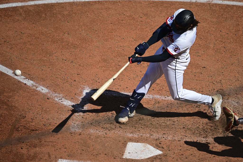 Cleveland Guardians' Bo Naylor hits a two-RBI double during the fourth inning of a baseball game against the Chicago White Sox, Sunday, Sept. 14, 2025, in Cleveland. (AP Photo/David Dermer)