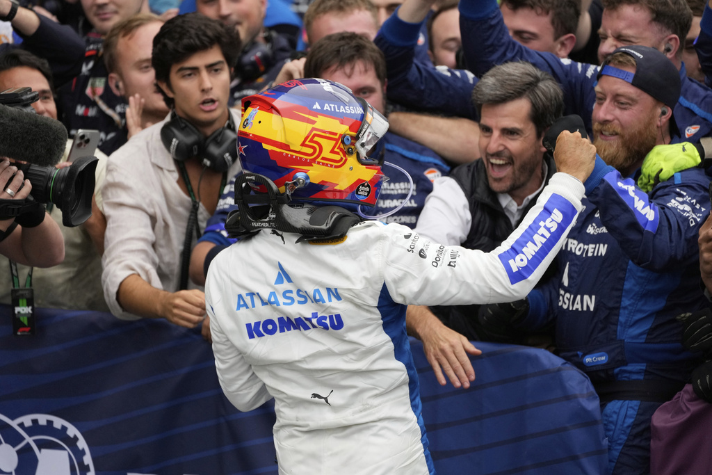 Williams driver Carlos Sainz of Spain celebrates second place with his team at the Azerbaijan Formula One Grand Prix in Baku, Azerbaijan, Sunday, Sept. 21, 2025. (AP Photo/Darko Bandic)