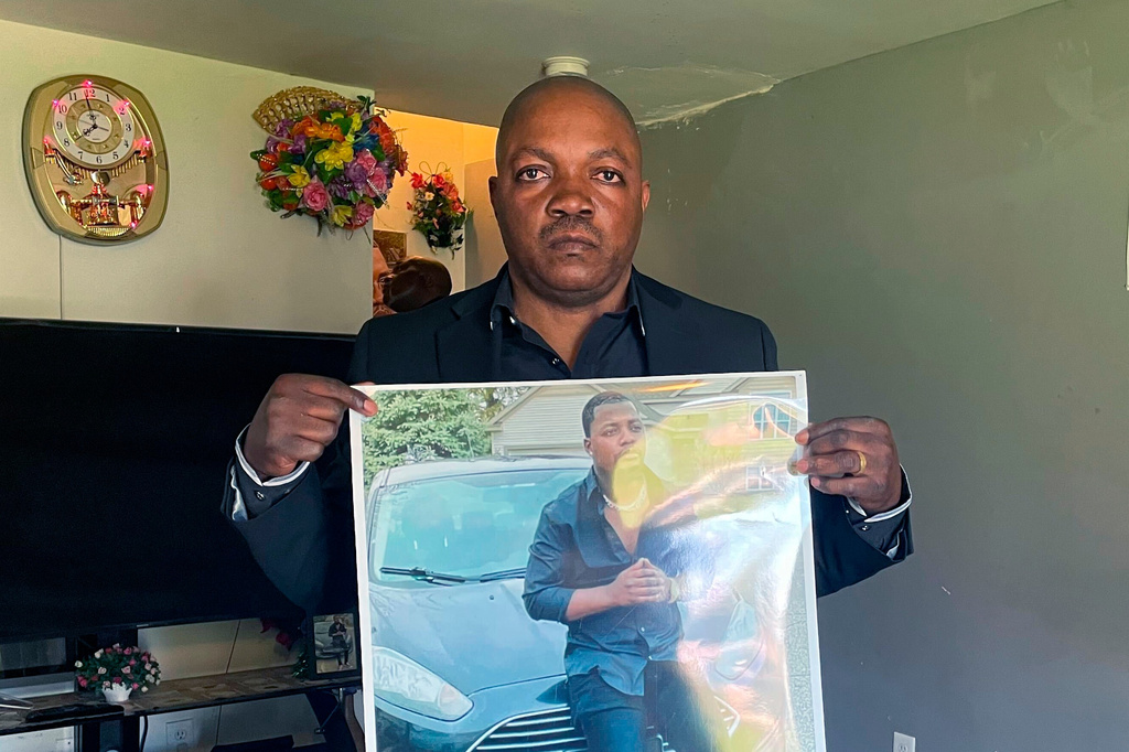 FILE - Peter Lyoya holds up a picture of his son, Patrick Lyoya, 26, at his home in Lansing, Mich., April 14, 2022. (AP Photo/Anna Nichols, File)
