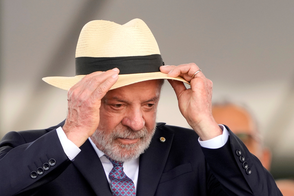 Brazilian President Luiz Inacio Lula da Silva adjusts his hat during a Soldier's Day ceremony at Army headquarters in Brasilia, Brazil, Tuesday, Aug. 25, 2026. (AP Photo/Eraldo Peres)