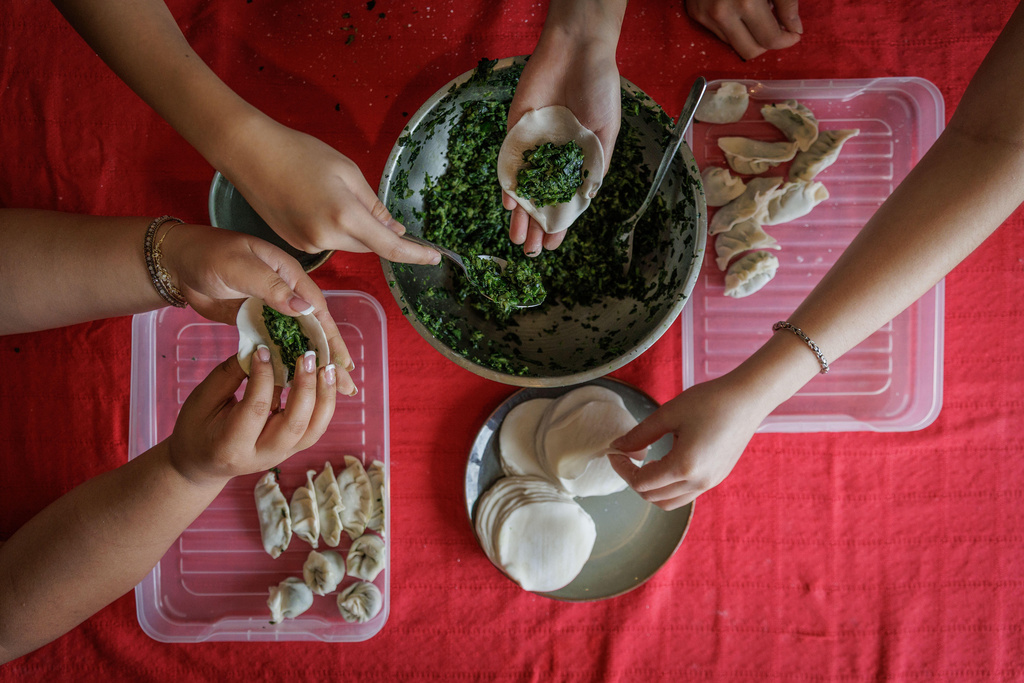 Friends gather to make dumplings on the first day of Lunar New Year in Hong Kong, Tuesday, Feb. 17, 2026. (AP Photo/May James)