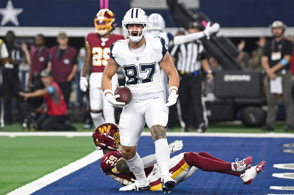 Dallas Cowboys tight end Jake Ferguson (87) celebrates after scoring a touchdown against the Washington Commanders in the second half during an NFL football game in Arlington, Texas, Sunday, Sept. 20, 2026. (AP Photo/Jessica Tobias)