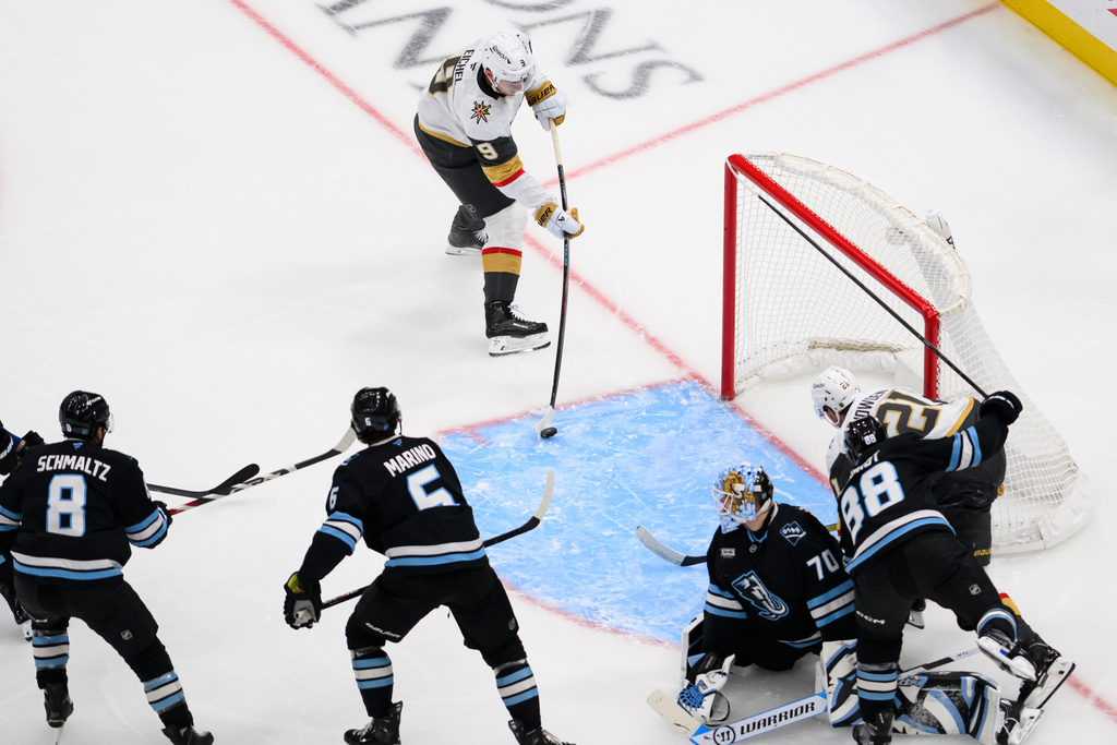 Vegas Golden Knights center Jack Eichel (9) shoots into an open net during the second period of an NHL hockey game against the Utah Mammoth, Thursday, Nov. 20, 2025, in Salt Lake City, Utah. (AP Photo/Tyler Tate)