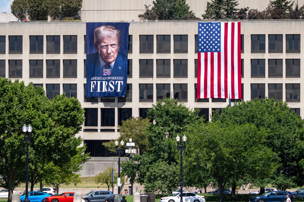FILE - A portrait of President Donald Trump hangs on the Labor Department headquarters near the Capitol in Washington, Aug. 25, 2025. (AP Photo/J. Scott Applewhite, file)