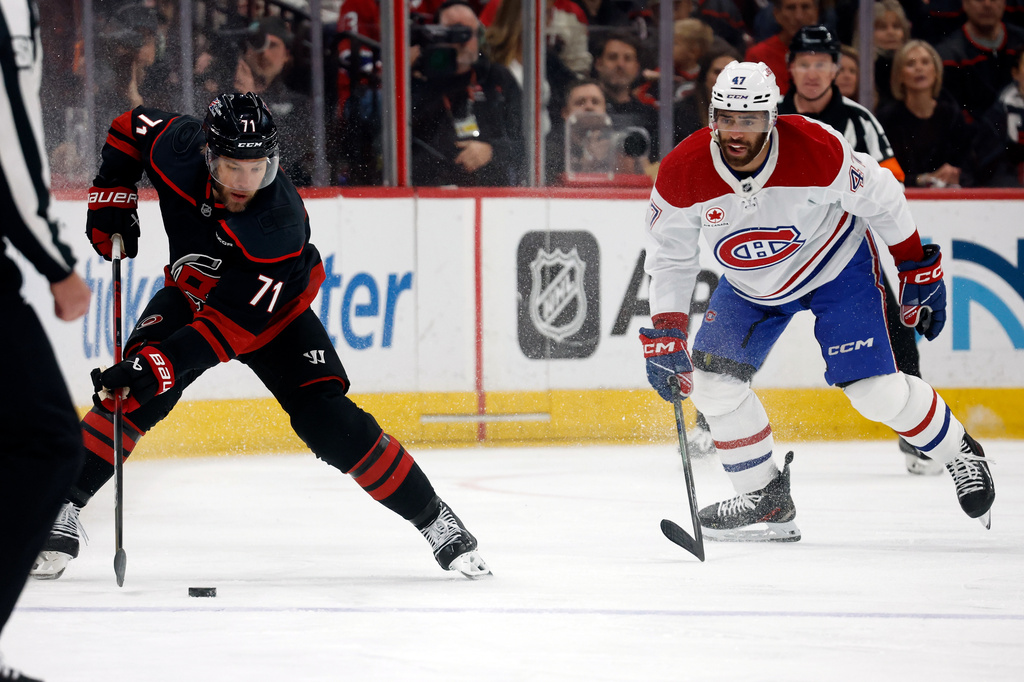 Carolina Hurricanes' Taylor Hall (71) controls the puck with Montreal Canadiens' Jayden Struble (47) nearby during the first period in Game 2 of the Eastern Conference finals NHL hockey Stanley Cup playoff series in Raleigh, N.C., Saturday, May 23, 2026. (AP Photo/Karl DeBlaker)