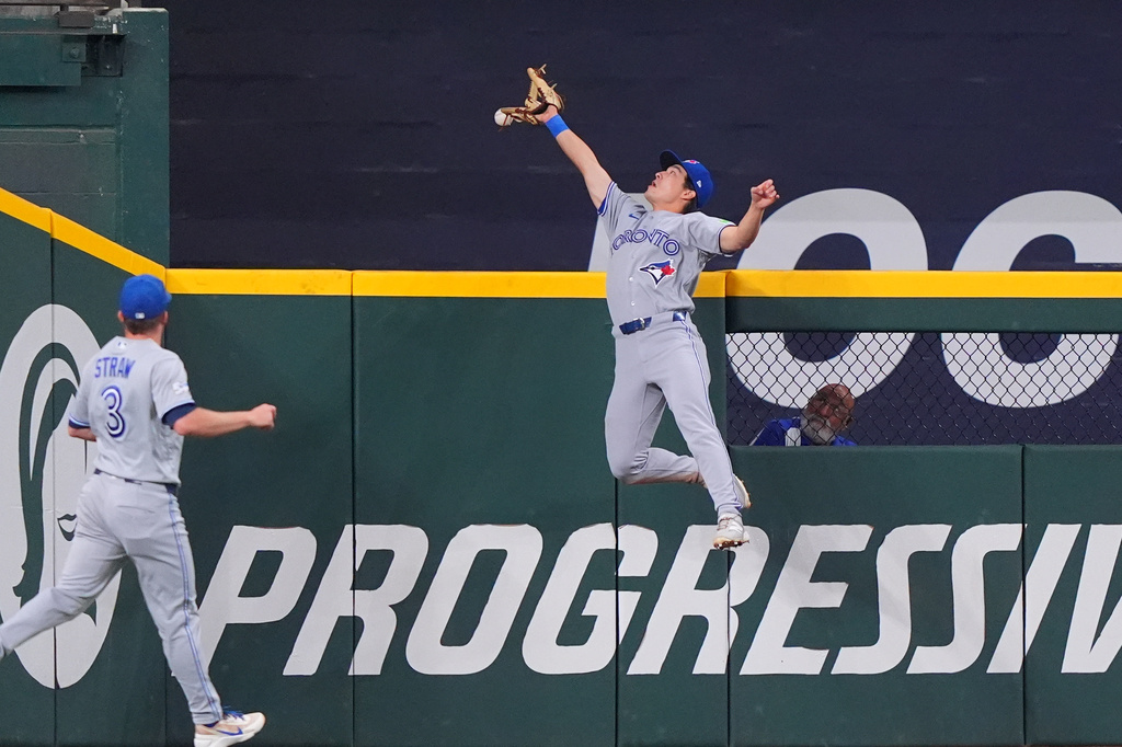 Toronto Blue Jays outfielder fielder Brett Bateman, right, cannot reach the ball at the wall as Myles Straw (3) looks on for a home run by Texas Rangers' Jake Burger during the fourth inning of a baseball game, Sunday, Sept. 20, 2026, in Arlington, Texas. (AP Photo/LM Otero)