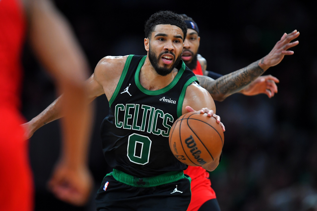 Boston Celtics forward Jayson Tatum (0) drives with the ball in front of Toronto Raptors forward Brandon Ingram in the second half of an NBA basketball game, Sunday, April 5, 2026, in Boston. (AP Photo/Steven Senne)