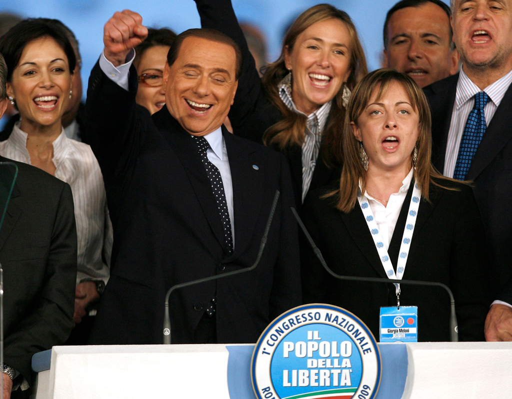 FILE - Italian premier Silvio Berlusconi is flanked by Minister of Equal Opportunities Mara Carfagna, left, Youth Policies Minister Giorgia Meloni, right, and Environment Minister Stefania Prestigiacomo, second from right, during a congress in Rome, March 29, 2009. (AP Photo/Alessandra Tarantino, File)