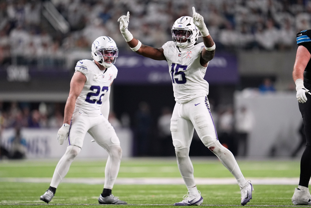 Minnesota Vikings linebacker Dallas Turner, right, celebrates a defensive stop with safety Harrison Smith during the second half of an NFL football game against the Detroit Lions, Thursday, Dec. 25, 2025, in Minneapolis. (AP Photo/Abbie Parr)