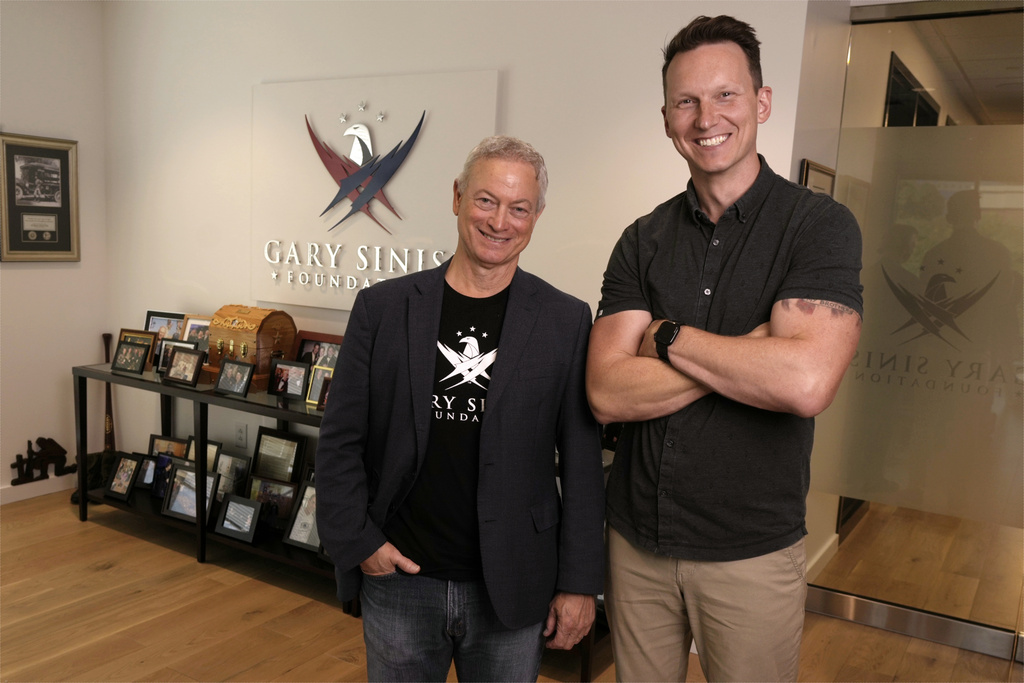 Gary Sinise, left, and CreatiVets executive director Richard Casper, right, pose for a photo in the Gary Sinise Foundation offices on Thursday, Sept. 10, 2025, in Franklin, Tenn. (AP Photo/Mark Humphrey)