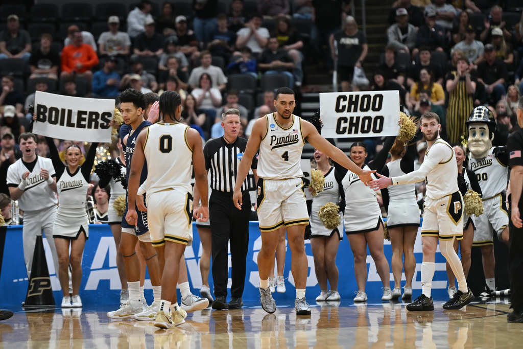 Purdue's Trey Kaufman-Renn (4) celebrates with teammate Braden Smith, right, and C.J. Cox (0) during the second half in the first round of the NCAA college basketball tournament against Queens University, Friday, March 20, 2026, in St. Louis. (AP Photo/Ali Overstreet)