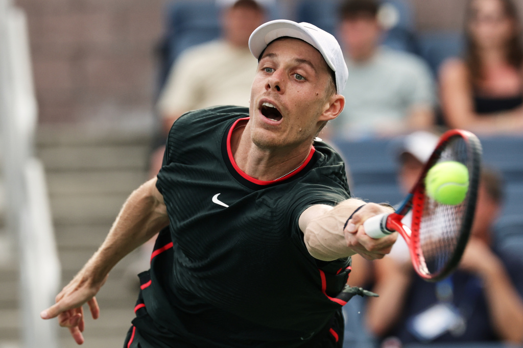 Denis Shapovalov, of Canada, returns the ball to Miomir Kecmanovic, of Serbia, during the first round of the U.S. Open tennis championships, Sunday, Aug. 30, 2026, in New York. (AP Photo/Adam Hunger)
