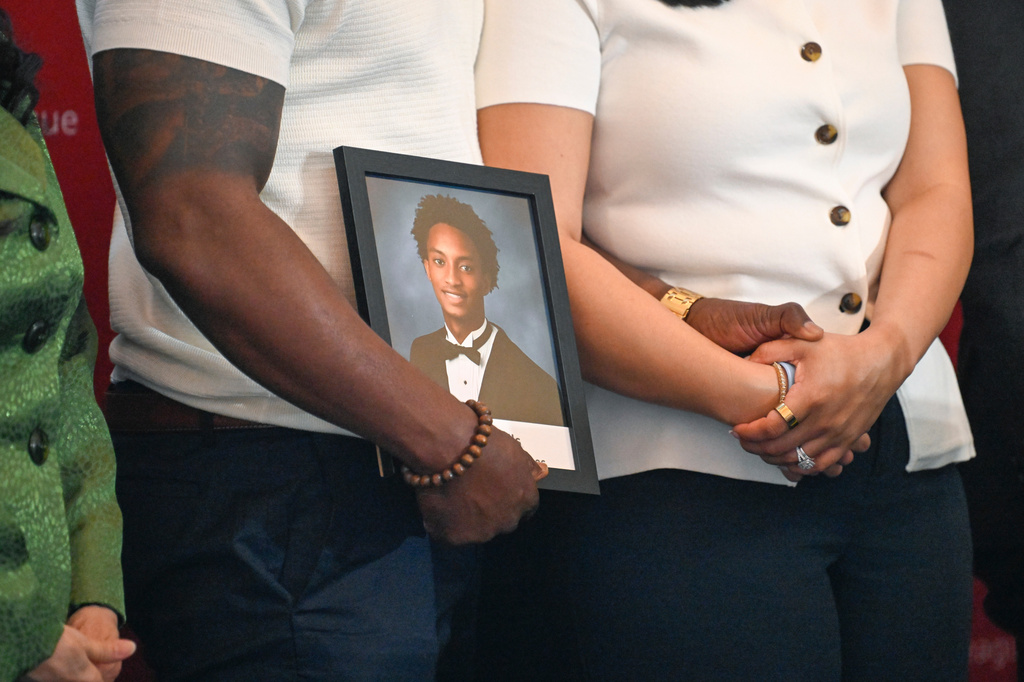Christine Wonsley and Elmore Wonsley, mother and step father of Nolan Wells, stand on a stage with a photo of their son as they appear at the National Urban League's annual conference to share updates on his death, as well as Daniel Erving, and Tyler Smith, Thursday, July 30, 2026, in Nashville, Tenn. (AP Photo/John Amis)