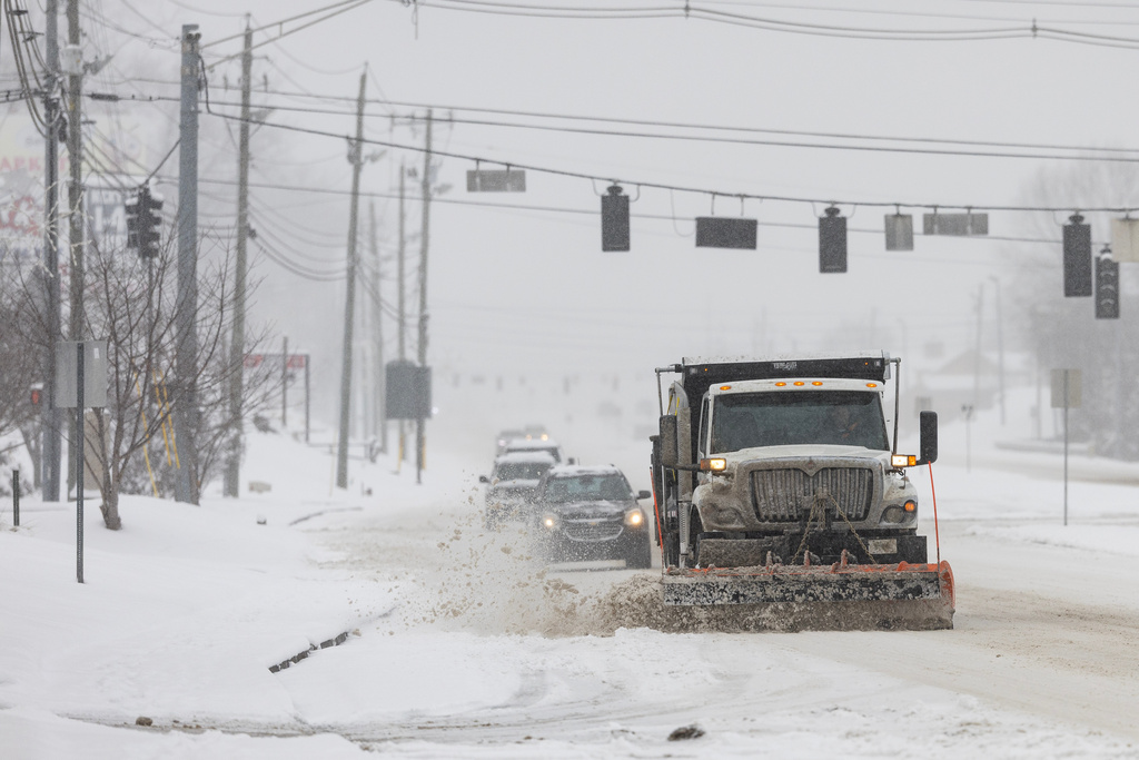 A truck plows snow along the parkway during a winter storm Saturday, Jan. 31, 2026, in Sevierville, Tenn. (AP Photo/Wade Payne)