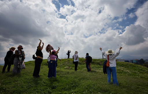 Tourists raise their arms at the Great Basement in the Cuicuilco Archaeological Zone during a tour organized by the National Institute of Anthropology and History in Mexico City, Sunday, Oct. 5, 2025. (AP Photo/Ginnette Riquelme) Tourists raise their arms at the Great Basement in the Cuicuilco Archaeological Zone during a tour organized by the National Institute of Anthropology and History in Mexico City, Sunday, Oct. 5, 2025. (AP Photo/Ginnette Riquelme)