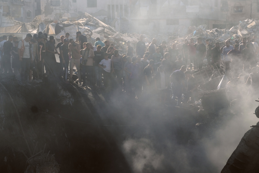 Palestinians inspect the rubble of a building destroyed in an Israeli airstrike in Gaza City, Monday, Aug. 24, 2026. (AP Photo/Jehad Alshrafi)