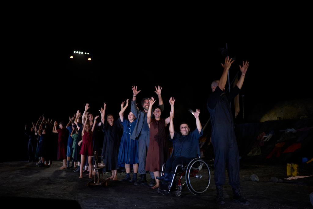Cast members with and without disabilities acknowledge the audience with a curtain call after a performance of Euripides' tragedy The Trojan Women, staged by the National Theatre of Greece at the Ancient Theater of Epidaurus, Greece, on Sunday, Aug. 2, 2026. (AP Photo/Petros Giannakouris)