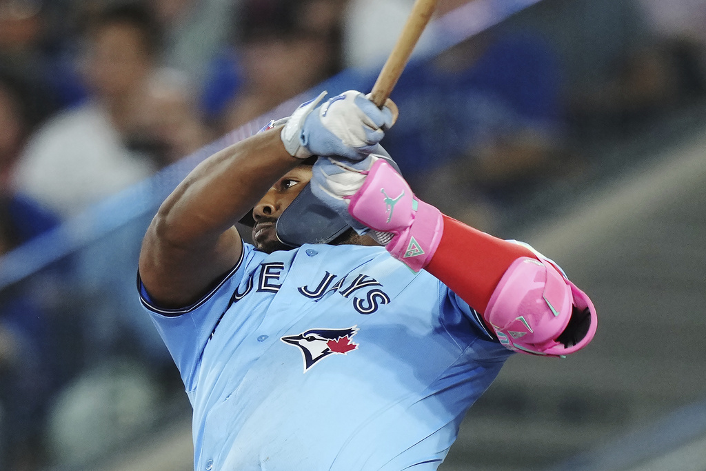 Toronto Blue Jays' Vladimir Guerrero Jr. (27) flies out against the Chicago Cubs during the fourth inning of a baseball game in Toronto on Wednesday, Aug. 13, 2025. (Nathan Denette/The Canadian Press via AP)