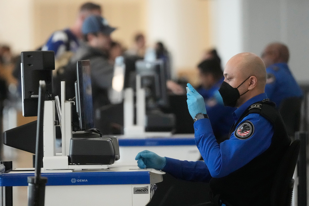 A Covenant Aviation Security Private Security Services agent checks the identifcation of a passenger at a security gate at San Francisco International Airport in San Francisco, Friday, Feb. 27, 2026. (AP Photo/Jeff Chiu)