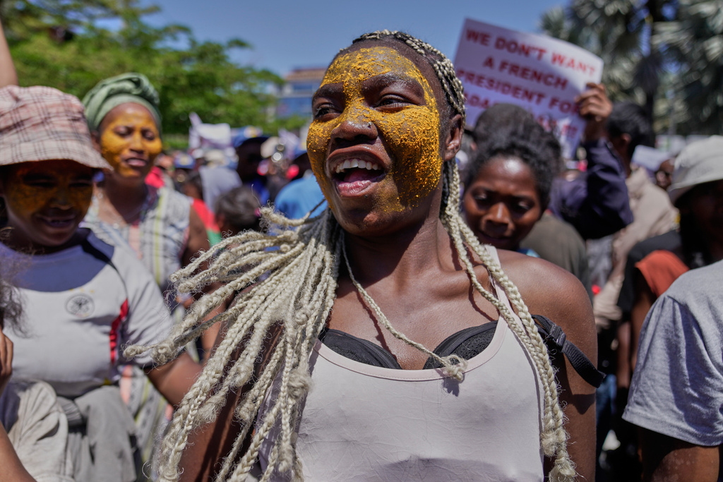 A woman dances during a protest calling for President Andry Rajoelina to step down in Antananarivo, Madagascar, Tuesday, Oct. 14, 2025. (AP Photo/Brian Inganga)