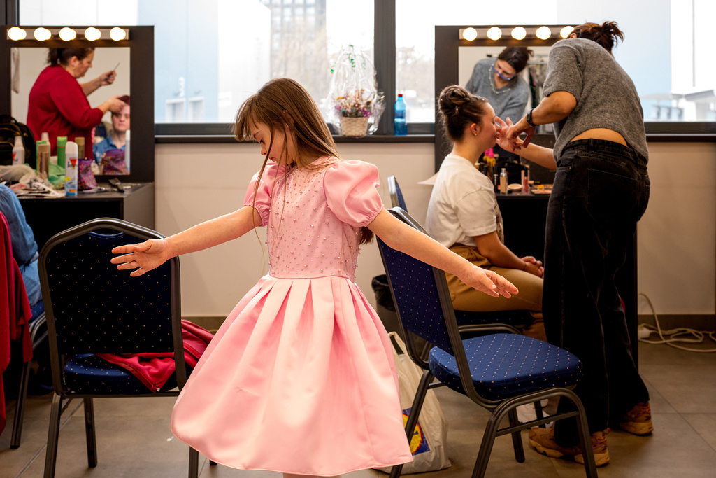 Marusika Burlaca dances before the SEEN Anonymous Seamstresses Gala, an event organised by the Down Plus Bucharest, an NGO supporting youngsters with Down Syndrome and other intellectual disabilities, in Bucharest, Romania, Wednesday, March 18, 2026, ahead of the World Down Syndrome Day, on March 21. (AP Photo/ Vadim Ghirda)