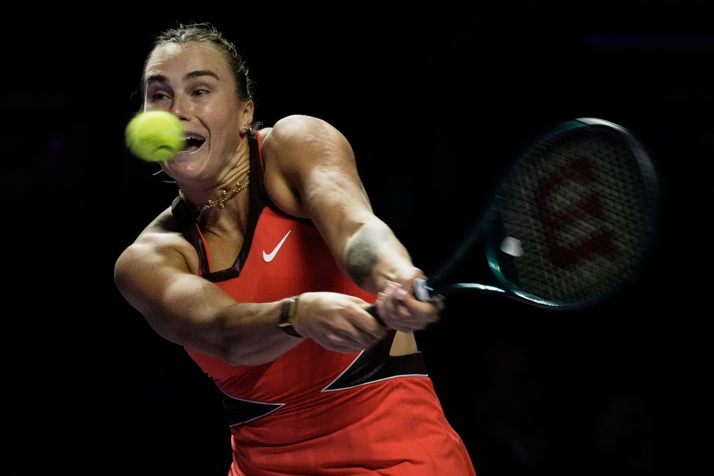 Aryna Sabalenka of Belarus plays a backhand return to Coco Gauff of the United States during their women's singles match at the WTA tennis finals in Riyadh, Saudi Arabia, Thursday, Nov. 6, 2025. (AP Photo/Fatima Shbair)