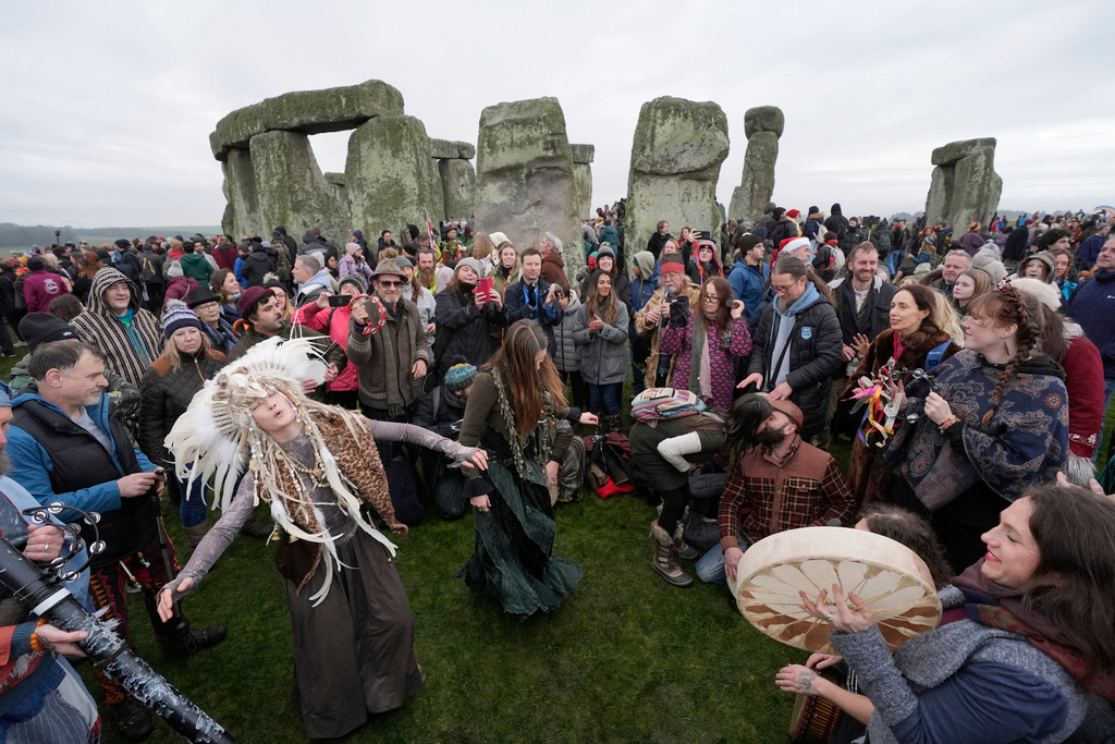 People take part in the winter solstice celebrations during sunrise at the Stonehenge prehistoric monument on Salisbury Plain in Wiltshire, England, Sunday, Dec. 21, 2025. (Andrew Matthew/PA via AP)