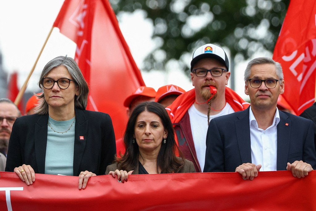 From left; Christiane Benner, chairwoman of IG Metall union, Daniela Cavallo, chairwoman of the General and Group Works Councils of Volkswagen, and Thorsten Groeger, IG Metall regional leader for Lower Saxony and Saxony-Anhalt take part in a march by employees of carmaker Volkswagen AG and IG Metall union members rally on the grounds of the Volkswagen headquarters on the day of the supervisory board meeting, in Wolfsburg, Germany, Thursday, July 9, 2026. (Lisi Niesner/Pool Photo via AP)