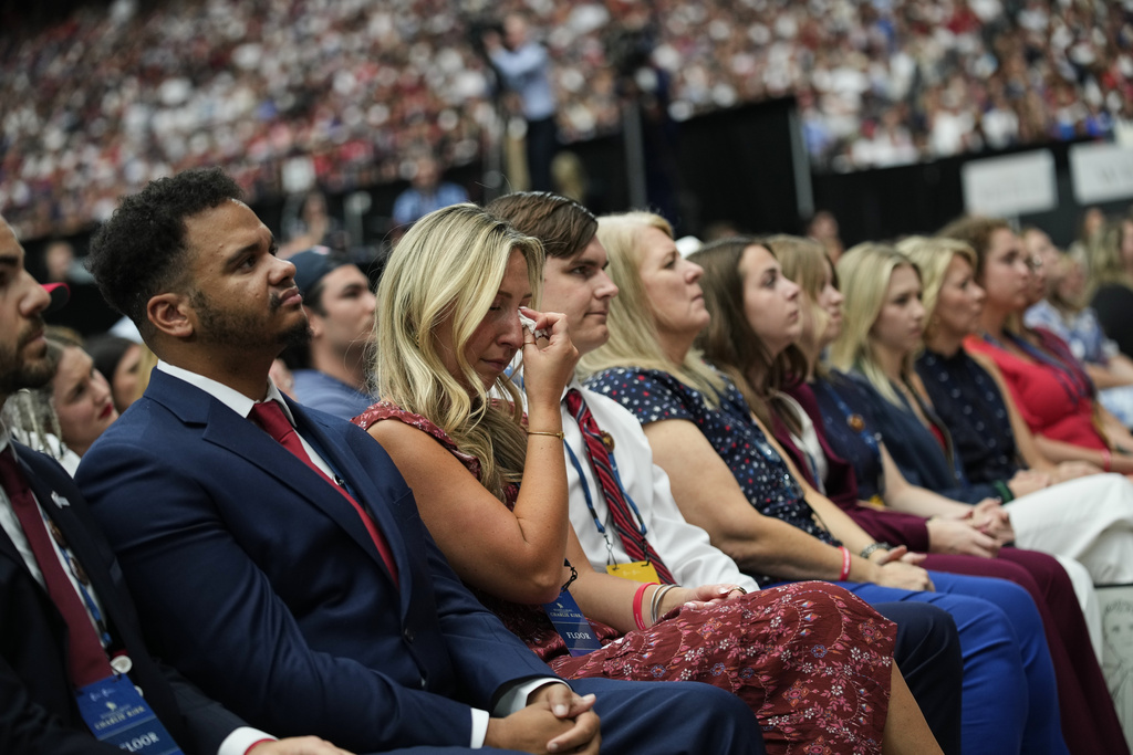 People listen as Erika Kirk speaks at a memorial for her late husband conservative activist Charlie Kirk, Sunday, Sept. 21, 2025, at State Farm Stadium in Glendale, Ariz. (AP Photo/John Locher)
