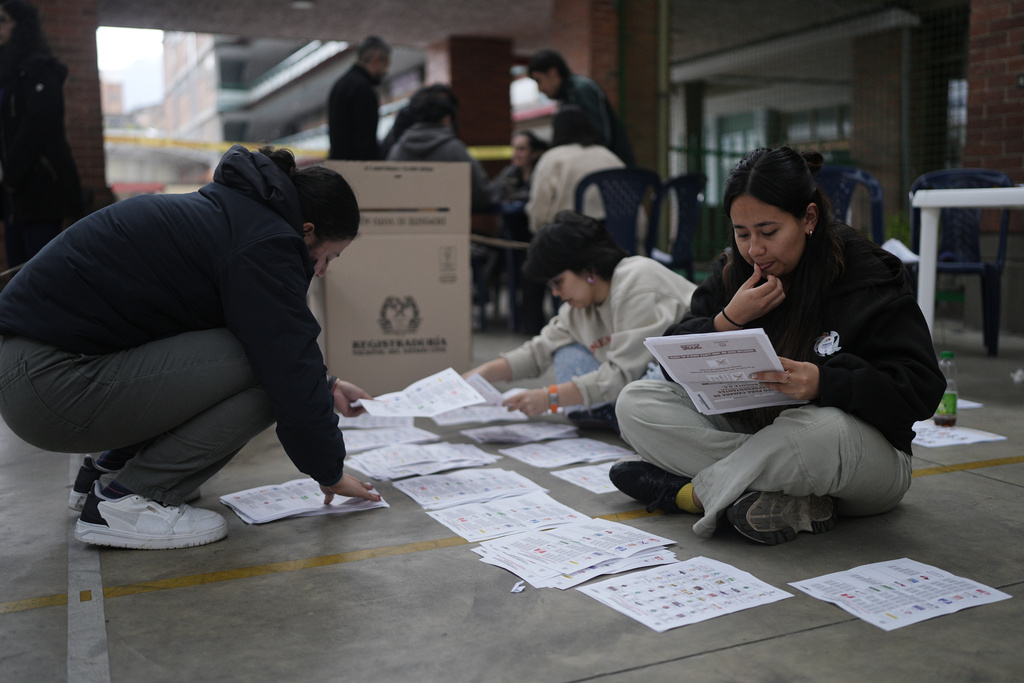 Election workers count ballots after voting ended after polls closed in legislative elections in Bogota, Colombia, Sunday, March 8, 2026. (AP Photo/Ivan Valencia)