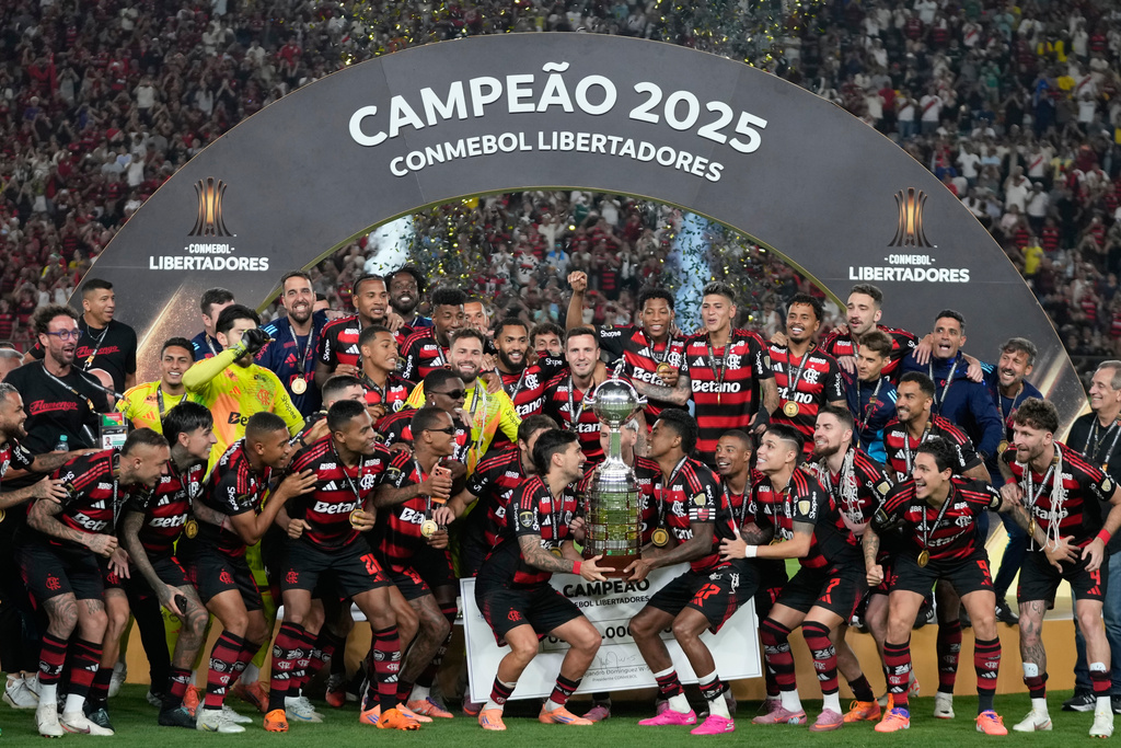 Players of Brazil's Flamengo celebrate with the trophy after defeating Brazil's Palmeiras in the Copa Libertadores final soccer match in Lima, Peru, Saturday, Nov. 29, 2025. (AP Photo/Martin Mejia)
