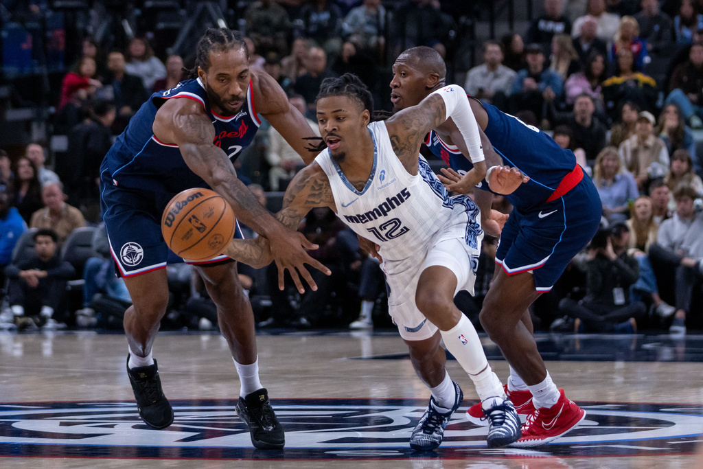 Memphis Grizzlies guard Ja Morant (12) chases the ball against Los Angeles Clippers players during the first half of an NBA basketball game Monday, Dec. 15, 2025, in Inglewood, Calif. (AP Photo/Ethan Swope)