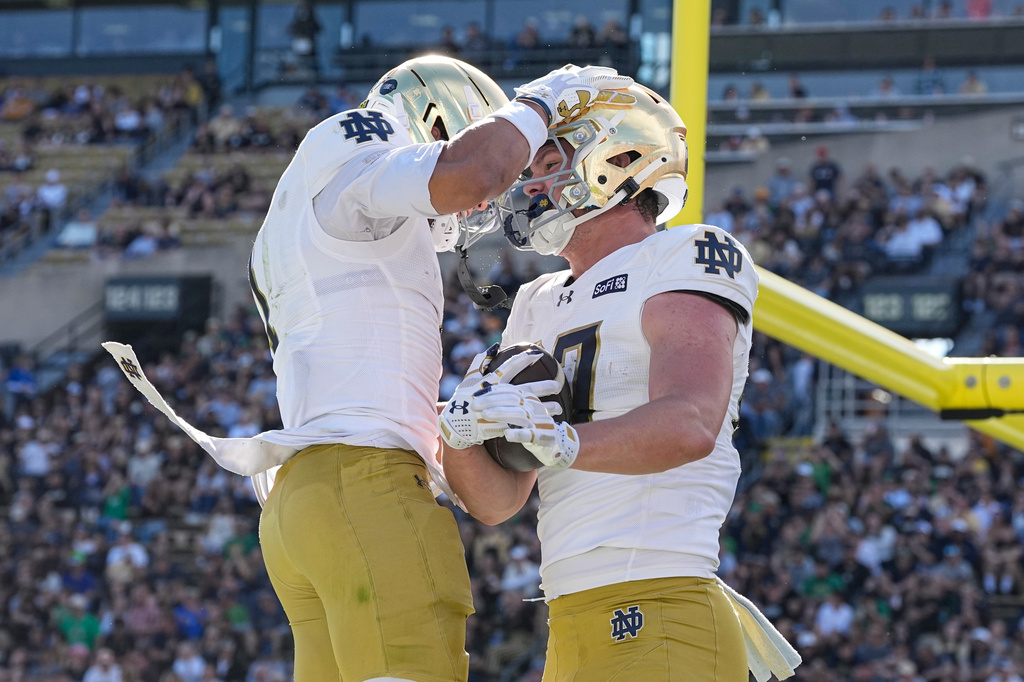 Notre Dame tight end Cooper Flanagan, right, celebrates a touchdown with wide receiver Jaden Greathouse (1) during the second half of an NCAA college football game against the Purdue in West Lafayette, Ind., Saturday, Sept. 26, 2026. (AP Photo/Michael Conroy)