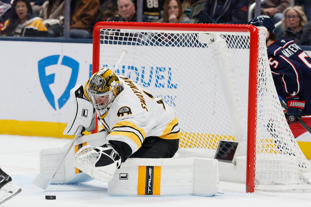 Boston Bruins' Jeremy Swayman makes a save against the Columbus Blue Jackets during the first period of an NHL hockey game, Sunday, March 29, 2026, in Columbus, Ohio. (AP Photo/Jay LaPrete)