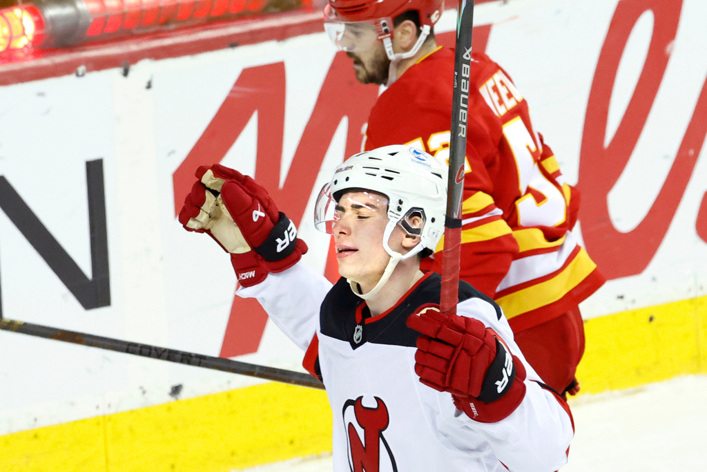 New Jersey Devils' Simon Nemec, bottom, celebrates after his overtime goal against the Calgary Flames during NHL hockey game action in Calgary, Alberta, Monday, Jan. 19, 2026. (Larry MacDougal/The Canadian Press via AP)