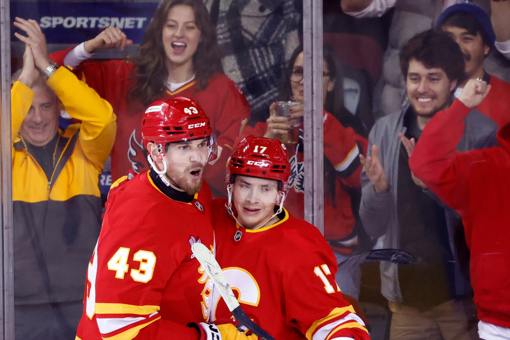 Calgary Flames' Adam Klapka, leftt, celebrates his goal with Yegor Sharangovich during second period NHL hockey action against the Columbus Blue Jackets in Calgary on Wednesday, Nov. 5, 2025. (Larry MacDougal/The Canadian Press via AP)