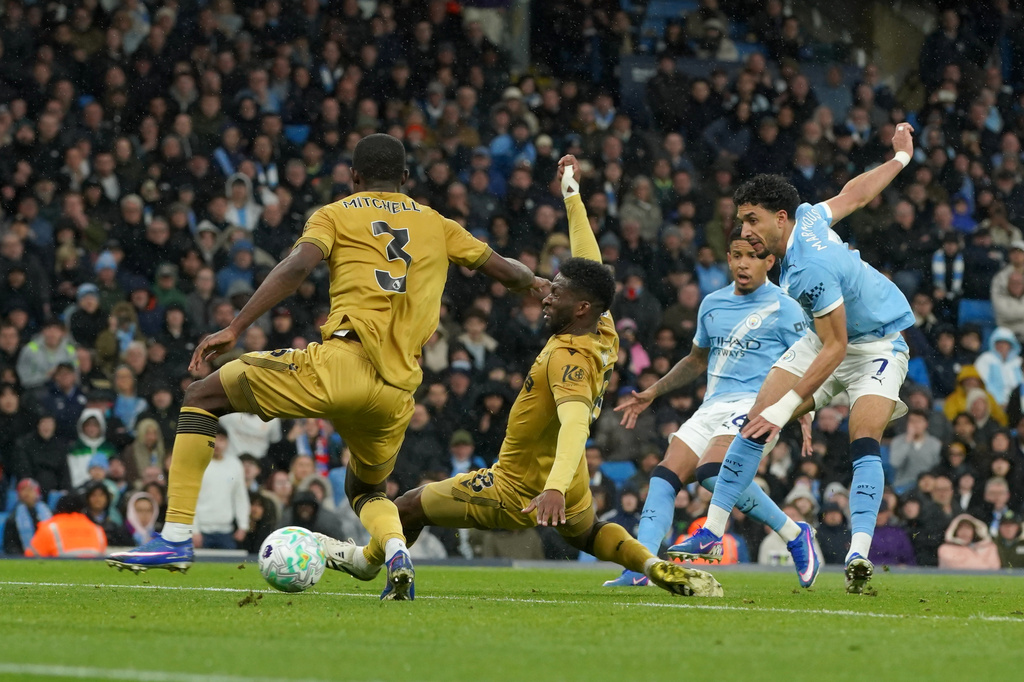 Manchester City's Omar Marmoush, right, scores his side's second goal during the English Premier League soccer match between Manchester City and Crystal Palace in Manchester, England, Wednesday, May 13, 2026. (AP Photo/Ian Hodgson)