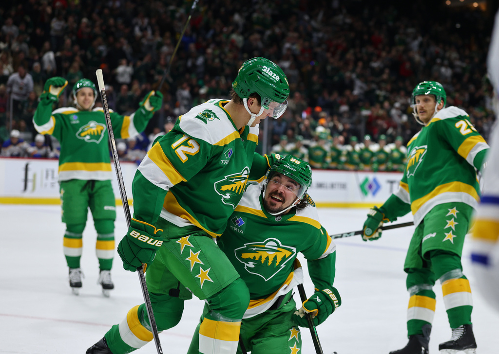 Minnesota Wild left wing Matt Boldy (12) and Minnesota Wild left wing Marcus Johansson (90) celebrate Boldy's goal against the Buffalo Sabres during the first period of an NHL hockey game Saturday, Nov. 29, 2025, in St. Paul, Minn. (AP Photo/Adam Bettcher)
