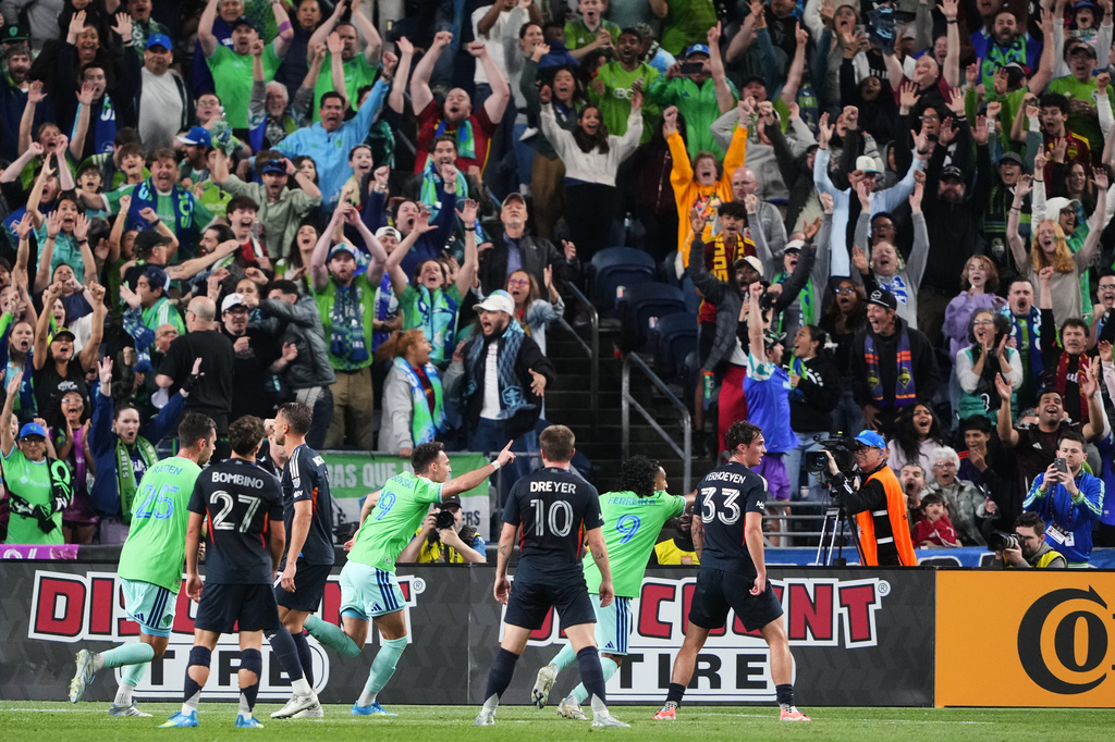 Seattle Sounders forward Daniel Musovski (19) celebrates his goal with teammates Jackson Ragen (25) and Jesús Ferreira (9) as San Diego FC's Luca Bombino (27), Anders Dreyer (10) and Oscar Verhoeven (33) look on during the second half of an MLS soccer match, Saturday, May 9, 2026, in Seattle. (AP Photo/Lindsey Wasson)