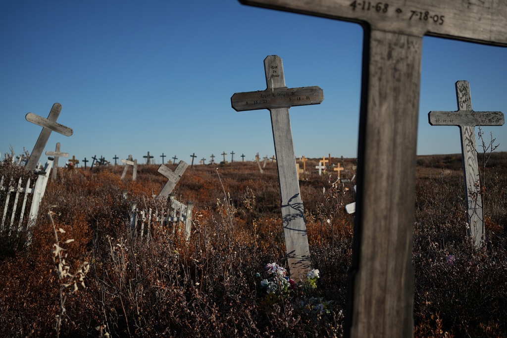 Grave markers are tilted due to thawing permafrost at a cemetery in Kotzebue, Alaska, Friday, Sept. 26, 2025. (AP Photo/Annika Hammerschlag)