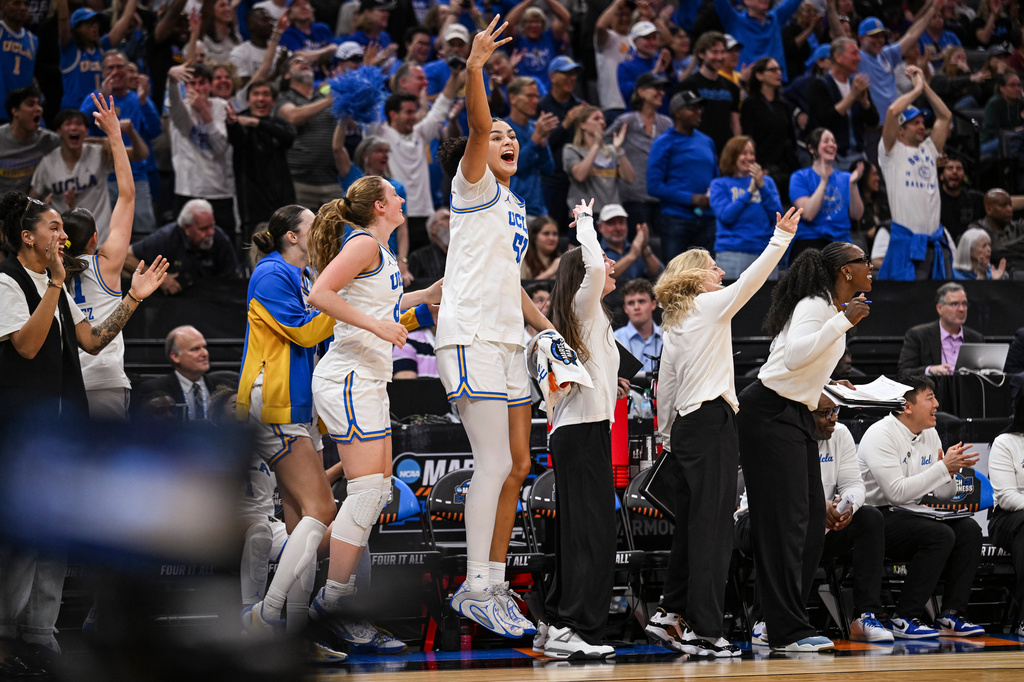 UCLA center Lauren Betts (51) reacts after a three point basket against Minnesota during the second half in the Sweet 16 of the NCAA college basketball tournament Friday, March 27, 2026, in Sacramento, Calif. (AP Photo/Justine Willard)