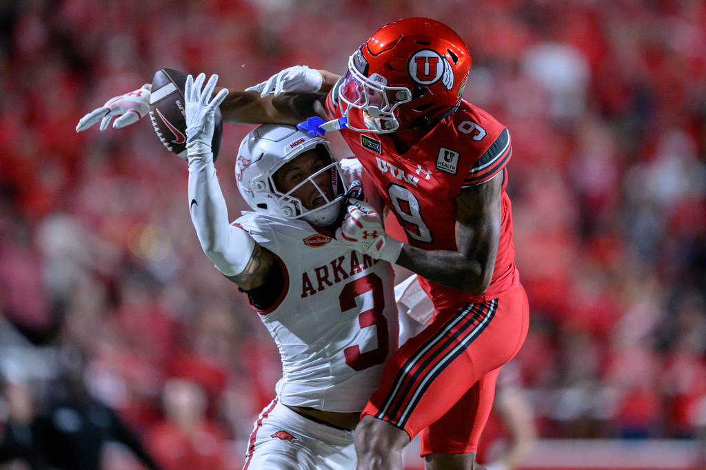 Utah cornerback Elijah Davis (9) defends the ball away from Arkansas wide receiver CJ Brown (3) during the first half of an NCAA college football game Saturday, Sept. 12, 2026, in Salt Lake City. (AP Photo/Tyler Tate)