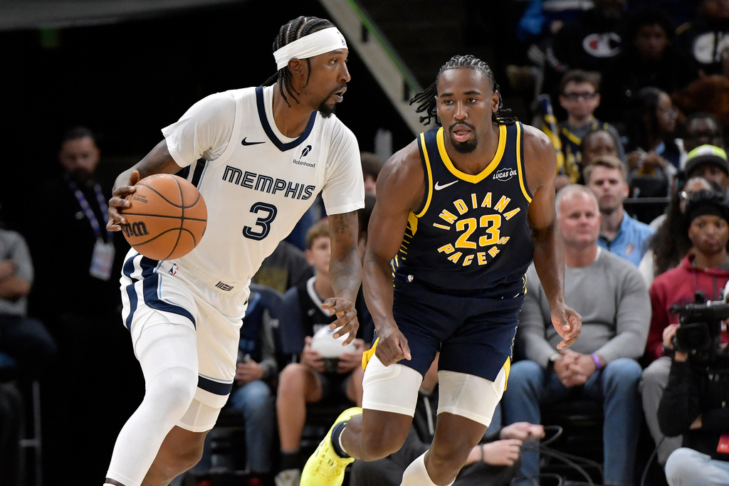 Memphis Grizzlies guard Kentavious Caldwell-Pope (3) handles the ball against Indiana Pacers guard Aaron Nesmith (23) in the first half of an NBA basketball game, Saturday, Oct. 25, 2025, in Memphis, Tenn. (AP Photo/Brandon Dill)