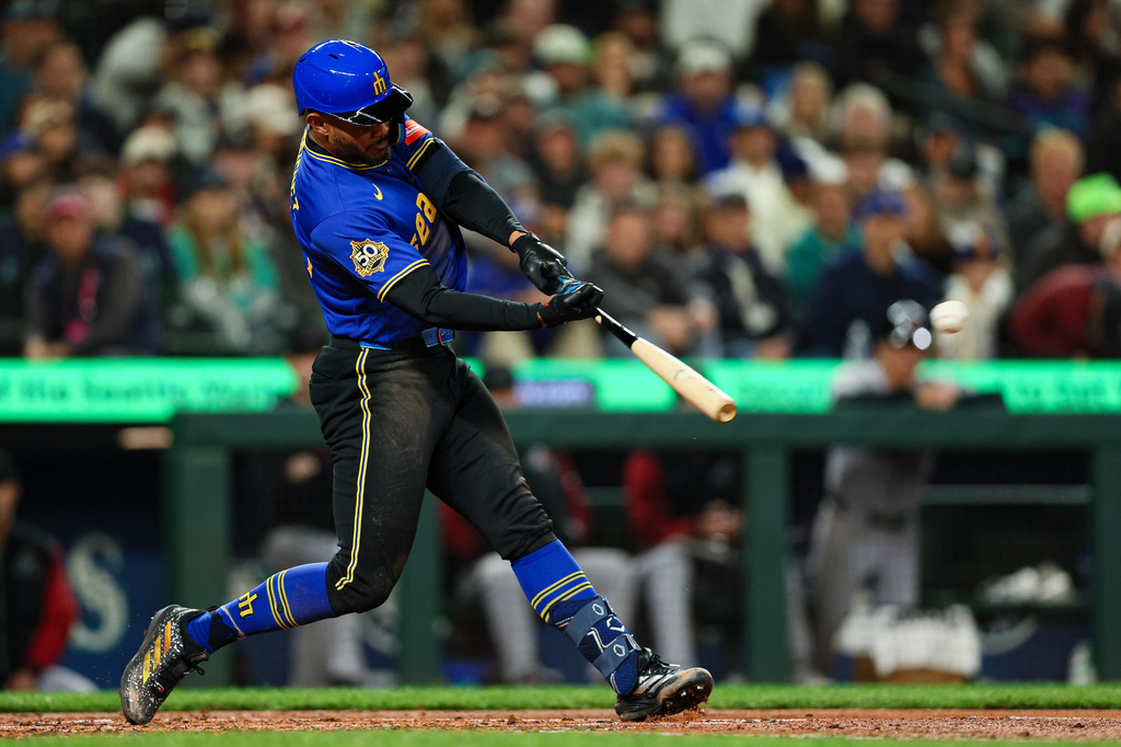 Seattle Mariners' Julio Rodríguez hits a two-run home run against the Arizona Diamondbacks during the third inning of a baseball game Friday, May 29, 2026, in Seattle. (AP Photo/Caean Couto)